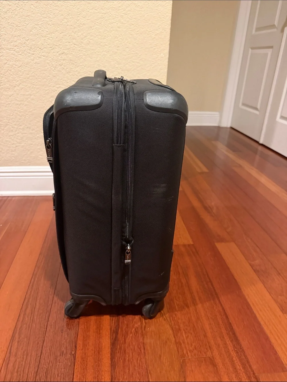 Tumi Black Carry-On Spinner with Front Zip Pocket